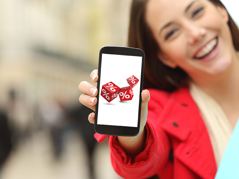 Shopper with shopping bags showing phone